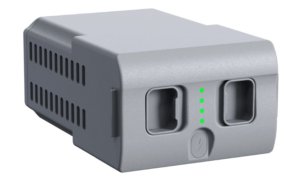 Bateria UNITREE Go2 Long Range Zdjęcie studyjne, przedstawiające pod kątem szary akumulator do robota Unitree ze wskaźnikiem naładowania (cztery zielone diody LED). Na bocznej ściance baterii widoczne są podłużne otwory wentylacyjne, sugerujące chłodzenie.