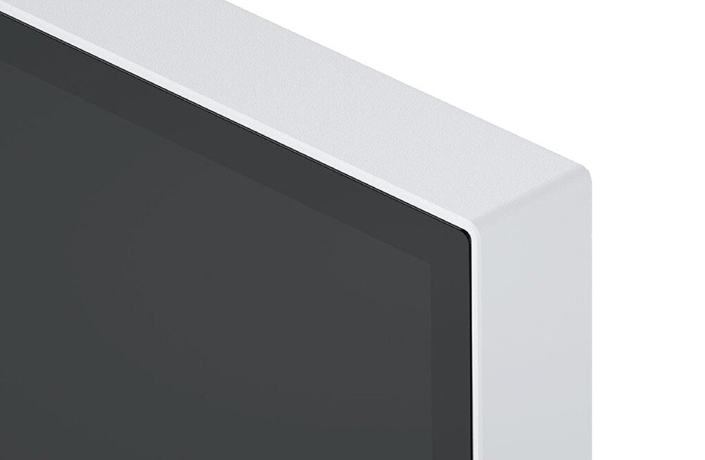 Monitor EIZO FlexScan EV2740X-WT Zbliżenie na górny róg monitora w białej obudowie. Widoczna wąska ramka otaczająca ekran oraz struktura powierzchni obudowy, ramka, wygląd, głośniki