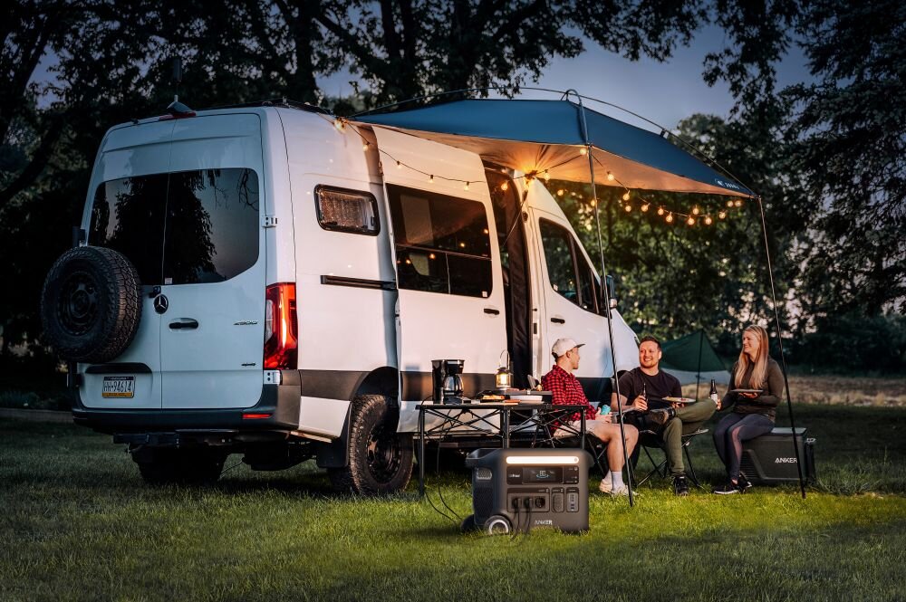 Stacja zasilania ANKER Solix F2600 2560 Wh 2300W, biwakowanie, praca, pole, solarne, USB, para przy kamperze biwakuje, na pierwszym planie stacja zasilania