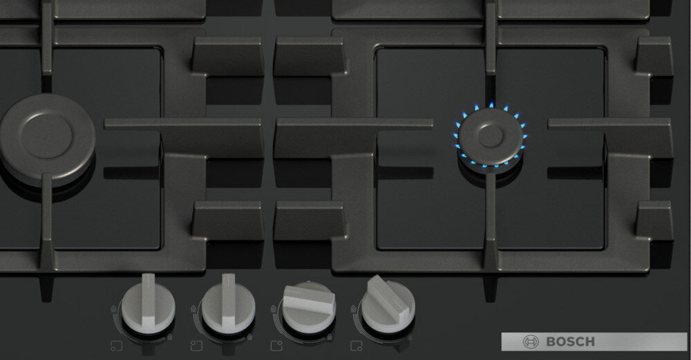PŁYTA BOSCH PNH6B6K40 Na zdjęciu widać fragment płyty gazowej z czterema palnikami, spośród których jeden jest aktywny i otoczony niebieskim płomieniem. Pod rusztem znajdują się cztery srebrne pokrętła do regulacji gazu, umożliwiające precyzyjne sterowanie pracą urządzenia zapalanie jedną ręką łatwe pokrętło szybkie bezpieczne płomień bez zapałek wygodne użytkowanie