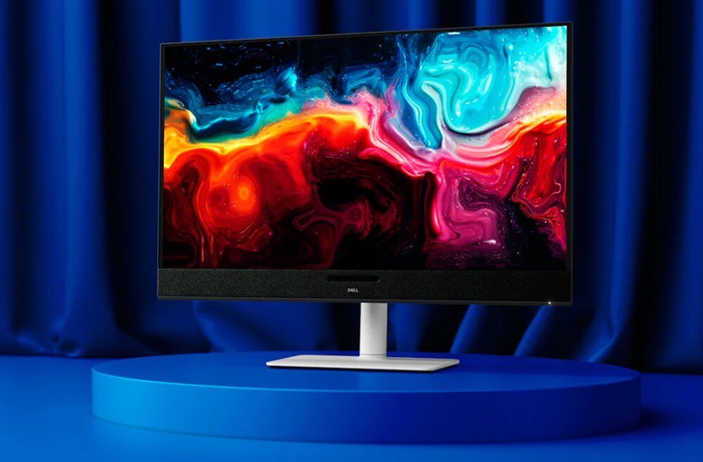 Monitor DELL S3225QC Monitor Dell z cienkimi ramkami i pasem głośników pod ekranem wyświetlający kolorowe abstrakcje, umieszczony na białej podstawie na niebieskim tle