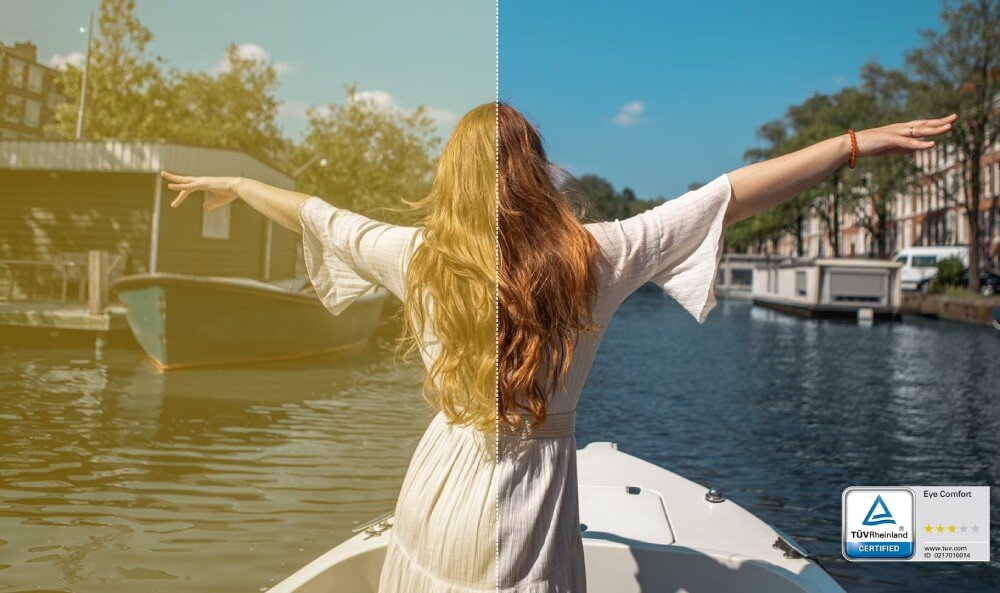 Monitor DELL S3225QC Kobieta z tyłu z rozłożonymi ramionami stojąca na łodzi, obraz podzielony pionowo pokazujący różnicę w tonacji kolorów z certyfikatem TÜV Rheinland Eye Comfort
