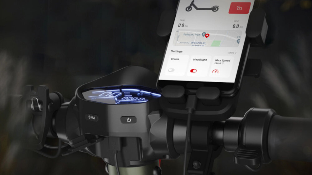 Hulajnoga elektryczna SHARP EM-KT4CEU-G 35km 350W Amortyzacja 10 cali Oliwkowo-szary ciemne tło zbliżenie na kierownicę do kierownicy przymocowany telefon moduł Bluetooth aplikacja SHARP Life monitorowanie historii przejazdów sprawdzanie informacji na systemy Android i iOS złącze USB-A port ładowania środek transportu wsparcie w codziennym użytkowaniu