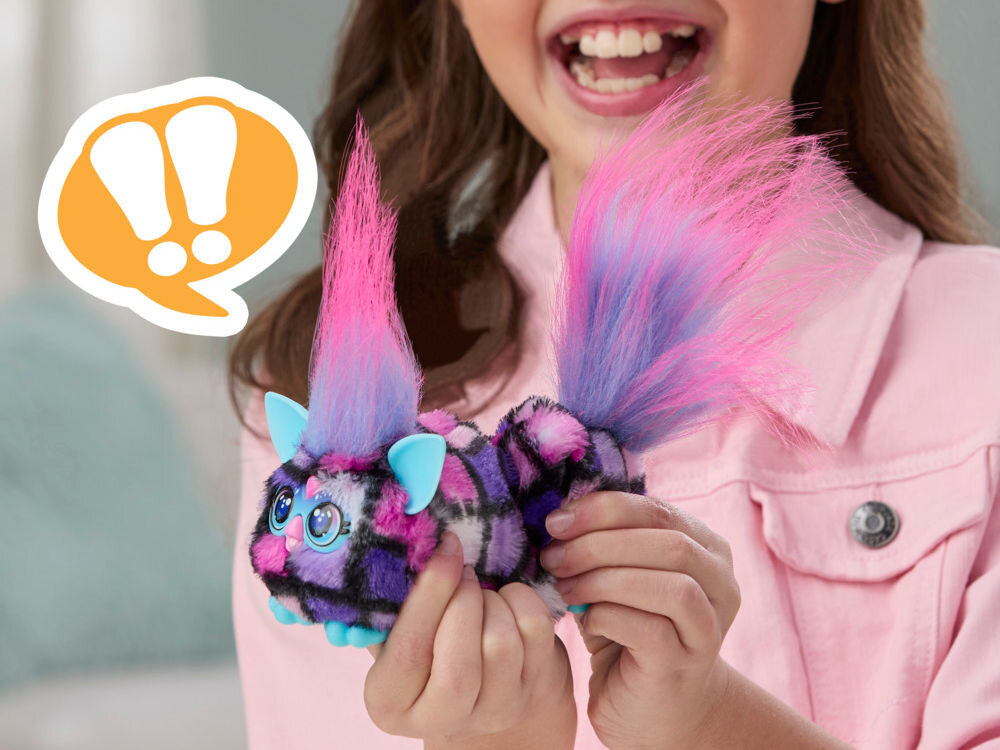 Maskotka HASBRO Furby DJ Furblets Dis-Co-Dazz G17805X0 Interaktywna maskotka Furby Furblets Luv-Lee w fioletową kratkę z różowym czubkiem włosów trzymana w dłoniach przez uśmiechniętą dziewczynkę.