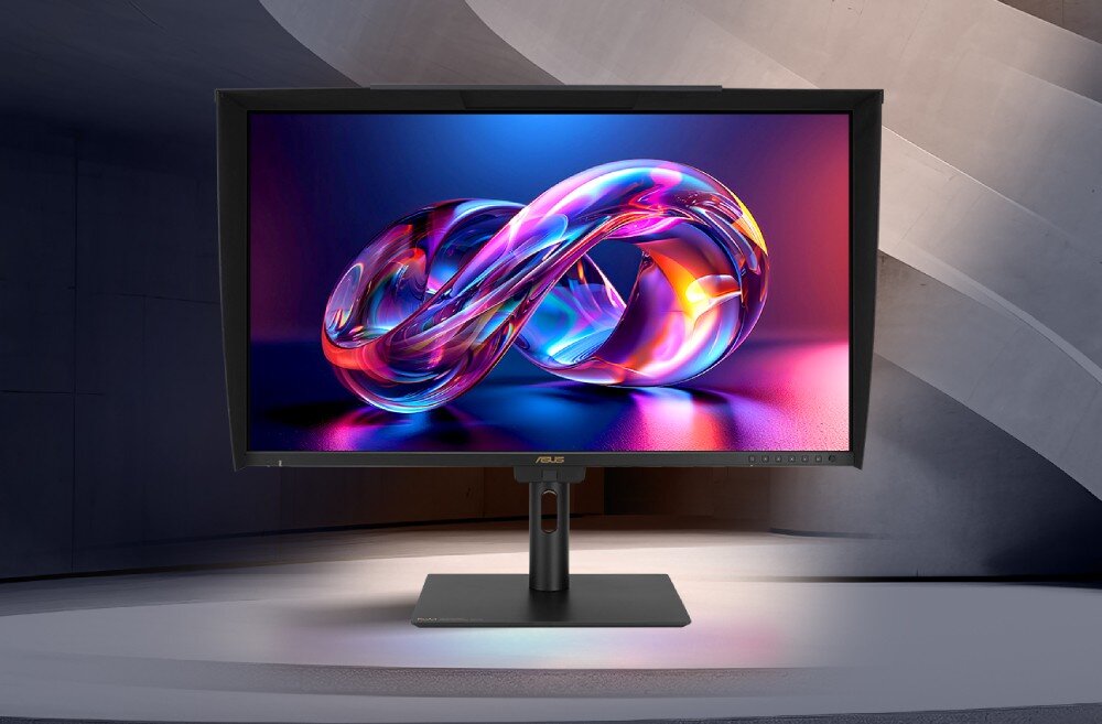 Monitor z wyświetlaczem prezentującym kolorową grafikę w kształcie nieskończoności. Na dolnej ramce widoczne jest logo ASUS.