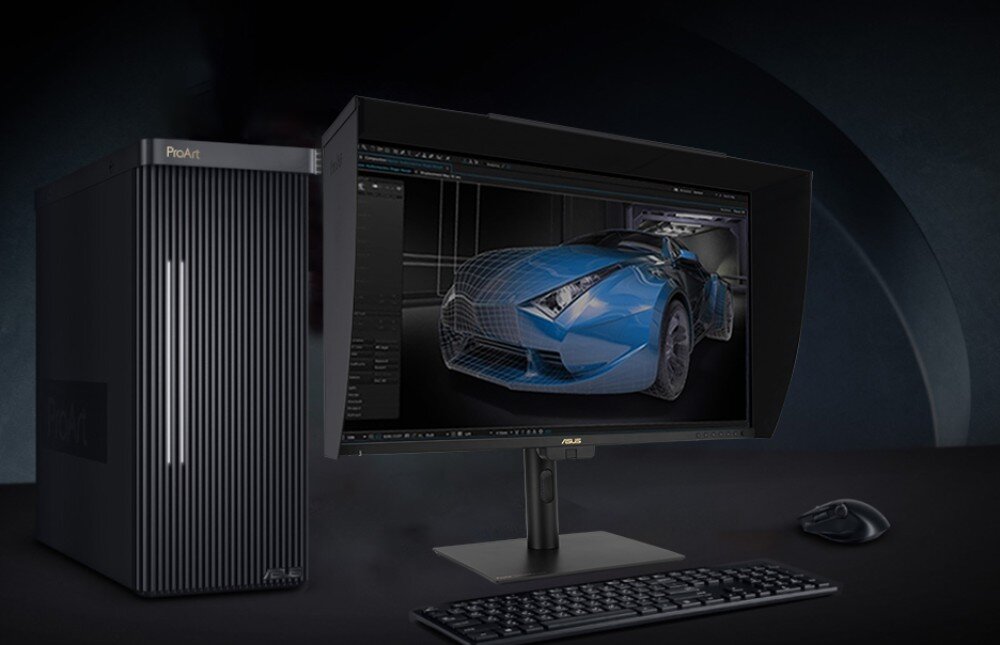 Na obrazie widoczny jest monitor ASUS z wyświetlanym modelem 3D niebieskiego samochodu. Obok monitora znajduje się komputer z napisem \'ProArt\' oraz klawiatura i myszka.