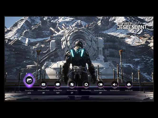 Na ekranie widoczna jest scena z gry \'The First Descendant\', przedstawiająca postać w futurystycznym stroju na tle górzystego krajobrazu i dużej struktury technologicznej. Na dole ekranu znajduje się menu z ikonami i tekstem: \'Game Genre Auto\', \'Virtual Aim Point Off\', \'Screen Ratio 16:9\', \'Minimap Zoom Off\', \'More Settings\', \'Game Motion Plus\', \'Sound Output\', \'Help Guide\'.