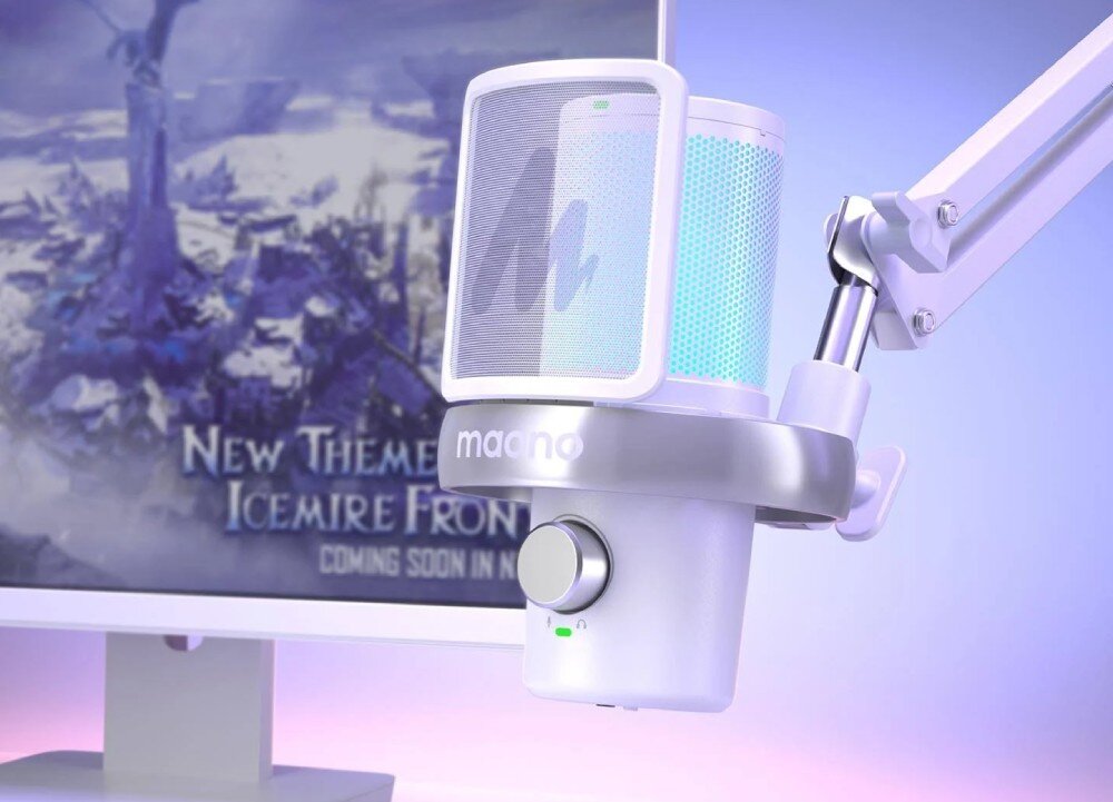 Na obrazie widoczny jest biały mikrofon z logo \'maono\', zamontowany na ramieniu. W tle znajduje się monitor z tekstem: \'NEW THEME ICEMIRE FRONT COMING SOON IN\'.