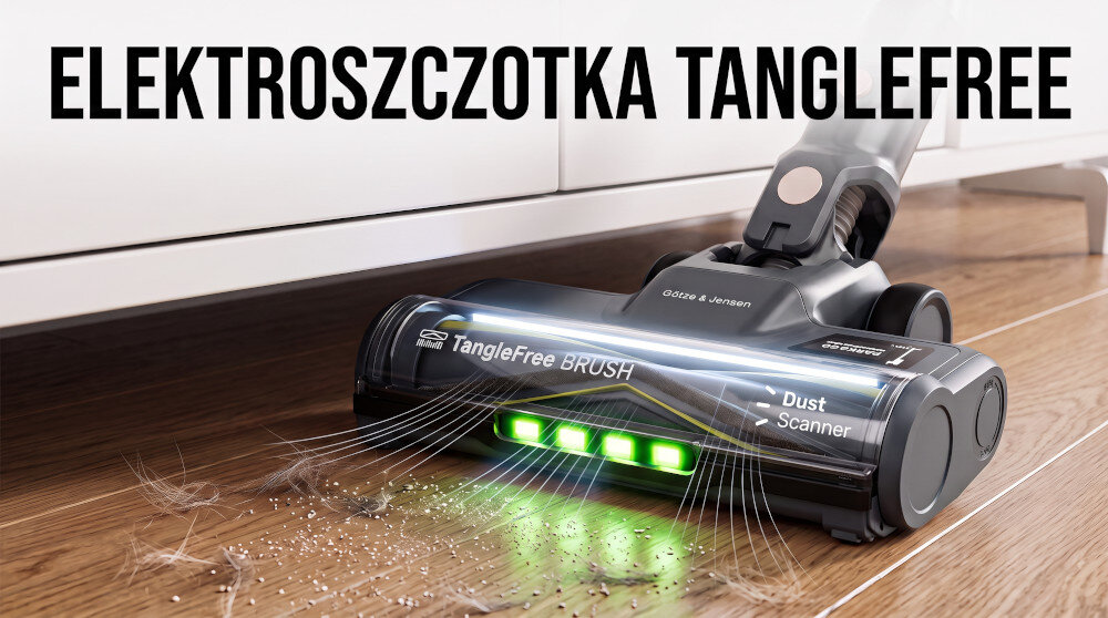 Na drewnianej podłodze znajduje się szczotka odkurzacza z napisem \'Tanglefree BRUSH\'. Obok leży wymienny wałek, a ręka trzyma element szczotki.