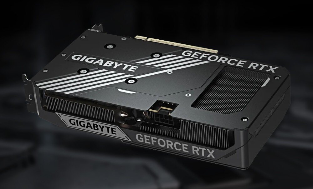 Karta graficzna GIGABYTE GeForce RTX 5060 Ti Windforce Max OC 16GB Tylna część karty graficznej widziana pod kątem, prezentująca złącze zasilania oraz metalowy backplate z wycięciem ułatwiającym przepływ powietrza, układ graficzny, rdzenie CUDA, pamięć VRAM, złącze
