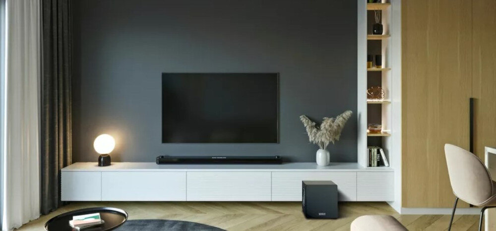 Subwoofer VELODYNE MiniVee X 8 dynamiczny bas kompaktowa obudowa moc, subwoofer stojący na ziemi obok szafki RTV w pomieszczeniu