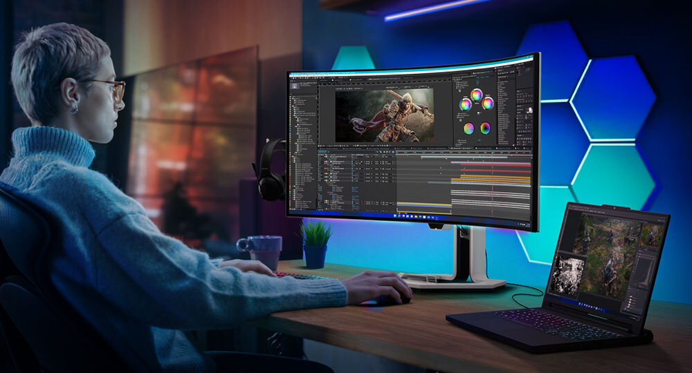 Monitor LENOVO Legion Pro 34WD-10 33.94 cala 3440x1440px OLED 240Hz 0.03 [GTG] Curved prezentacja monitora połączonego kablem z laptopem kobieta siedząca przy monitorze z włączonym programem graficznym w pokoju port USB-C do 140W HUB USB dodatkowe zasilanie złącze HDMI 2.1 FRL eARC elastyczność centrum rozrywki i pracy