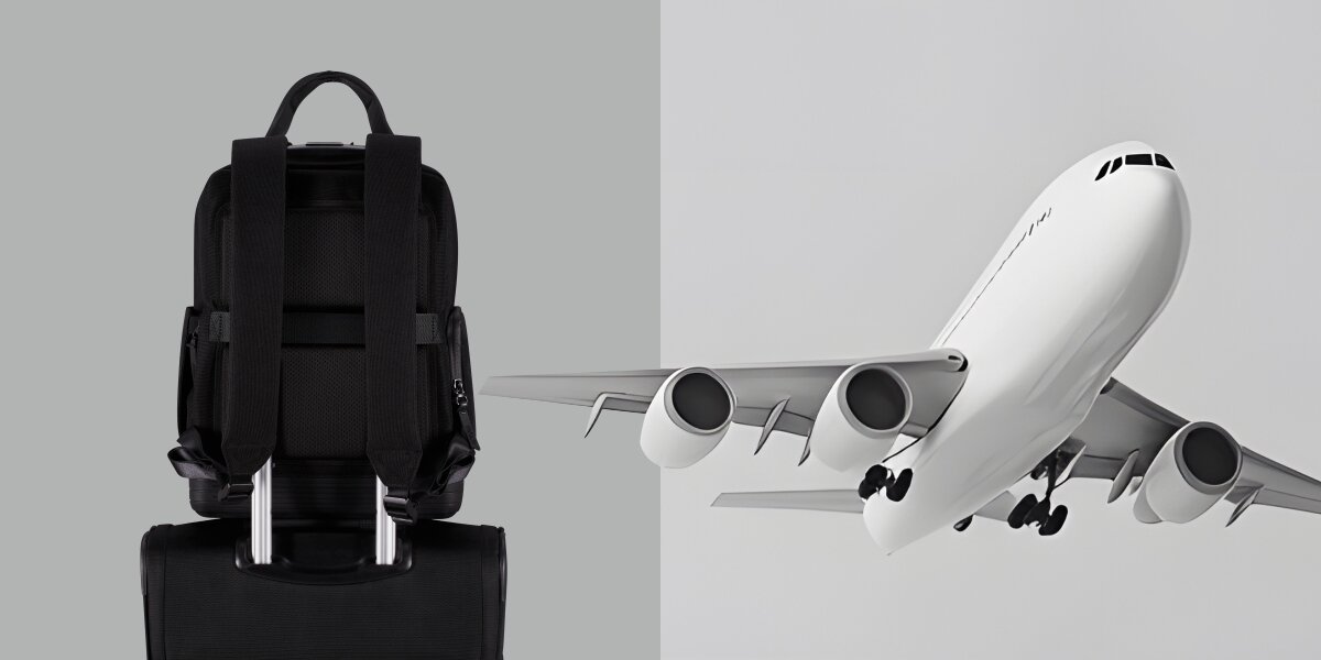 Plecak na laptopa AMERICAN TOURISTER Soulpack 15 cali Czarny plecak American Tourister zamontowany na rączce walizki podróżnej obok grafiki lecącego samolotu. 