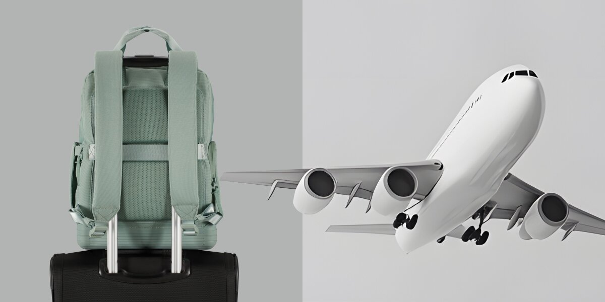 Plecak na laptopa AMERICAN TOURISTER Soulpack 15 cali  Iceberg Green Zielony Szałwiowy plecak American Tourister zamocowany na czarnej walizce podróżnej obok grafiki lecącego samolotu – idealny jako bagaż podręczny.