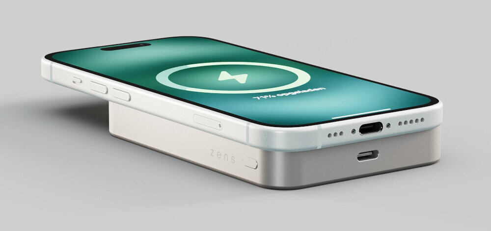 Na obrazie widoczny jest biały powerbank z napisem \'ZENS\', na którym leży smartfon z ekranem pokazującym ikonę ładowania i tekst \'71% completed\'.