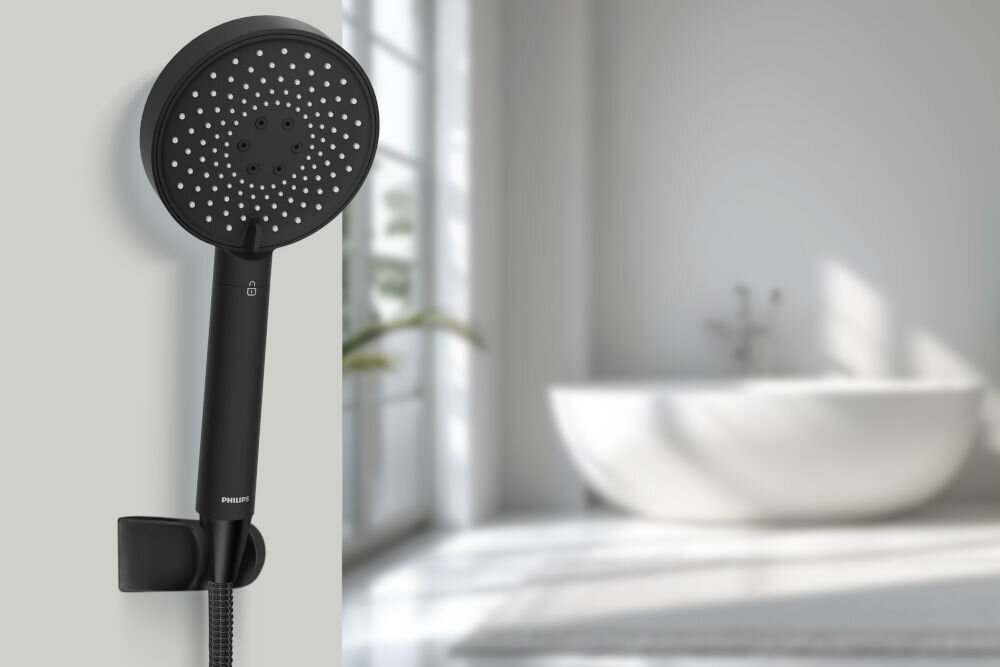 Słuchawka prysznicowa PHILIPS ASH1516BK Czarna słuchawka prysznicowa Philips zamontowana w uchwycie ściennym na tle jasnej łazienki. 