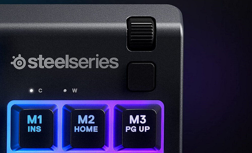 Klawiatura STEELSERIES Apex 3 TKL US Lawendowy zbliżenie na metalowy wałek i klawisze multimedialne na czarnym tle regulacja głośności i ustawień szybka reakcja