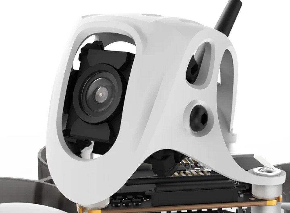 Dron BETAFPV Meteor65 Pro O4 Zbliżenie na białą obudowę kamery z czarnym obiektywem i widocznymi śrubami montażowymi