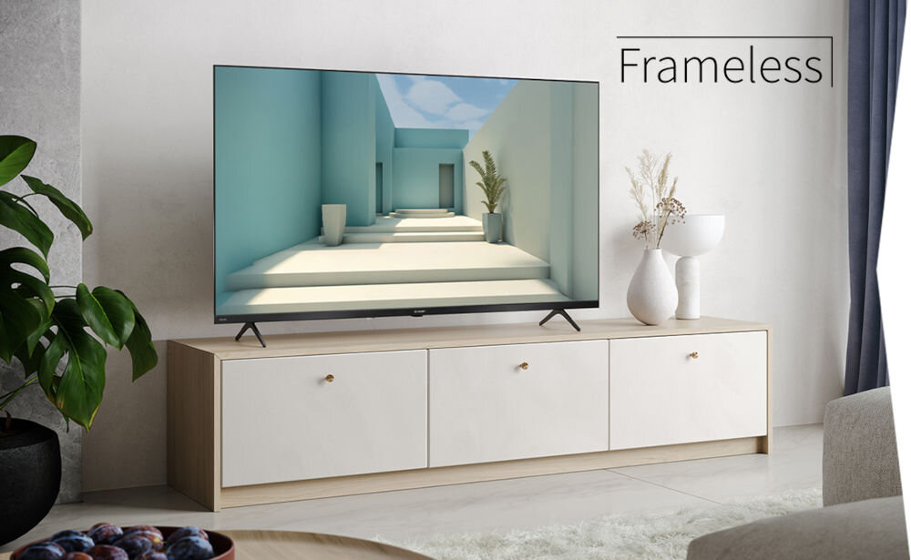 Telewizor SHARP 32HE2745E bezramkowy design smukła konstrukcja, telewizor stojący na komodzie w pomieszczeniu