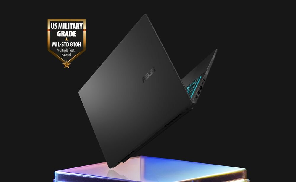 Laptop ASUS V16 z certyfikatem US Military Grade MIL-STD-810H Multiple Tests Passed na złotej tarczy lewitujący nad kolorową holograficzną platformą - Solidna konstrukcja MIL-STD 810H
