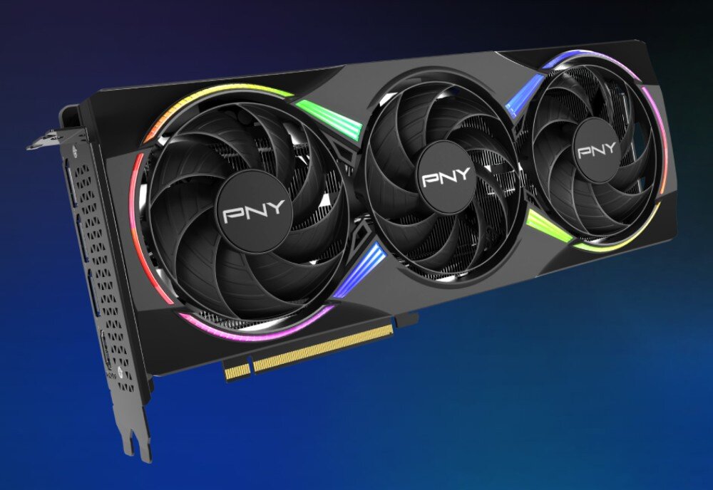 Karta graficzna PNY GeForce RTX 5060 Ti RGB OC Epic-X Overclocked Triple Fan 16GB Karta graficzna przedstawiona pod kątem na niebieskim tle, eksponująca system chłodzenia z trzema wentylatorami i podświetleniem RGB