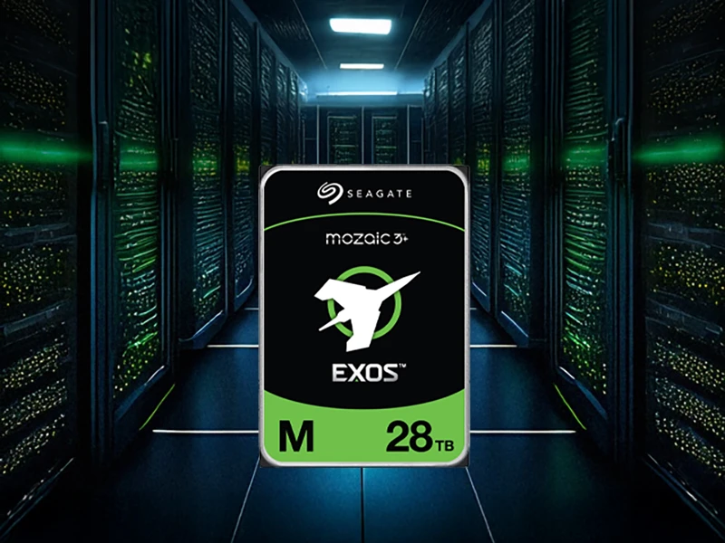Obraz przedstawia dysk twardy z logo \'Seagate\' oraz napisami \'mozaic 3+\', \'EXOS\', \'M\', \'28TB\'. W tle widoczna jest serwerownia z rzędem serwerów.