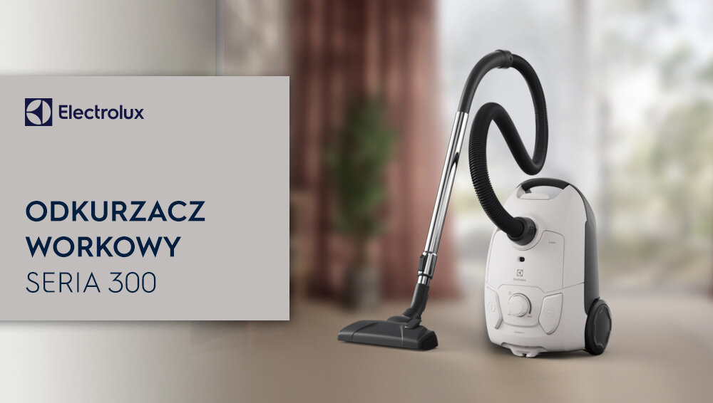 Obraz przedstawia odkurzacz workowy z serii 300 marki Electrolux, umieszczony na podłodze w jasnym pomieszczeniu. Po lewej stronie widoczny jest napis: \'Electrolux ODKURZACZ WORKOWY SERIA 300\'.