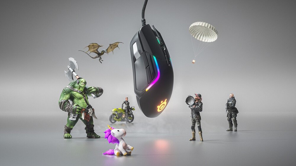 Na obrazie znajduje się mysz komputerowa z podświetleniem RGB, unosząca się w powietrzu. Wokół niej znajdują się postacie z gier, smok, motocykl i jednorożec.