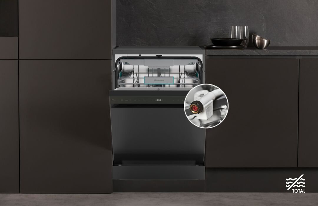 ZMYWARKA HISENSE HS663C90B Ciemna zabudowa kuchenna z ułożonymi na blacie brudnymi naczyniami, a w prawym dolnym rogu duże koło z powiększonym fragmentem elektrozaworu i węża dopływowego AquaStop, podkreślające pełne zabezpieczenie przed wyciekiem wody