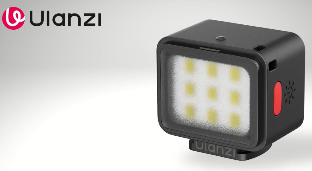 Na obrazie widoczna jest kompaktowa lampa LED z dziewięcioma diodami, obudowana w czarną obudowę z czerwonym przyciskiem. W lewym górnym rogu znajduje się logo \'Ulanzi\'.