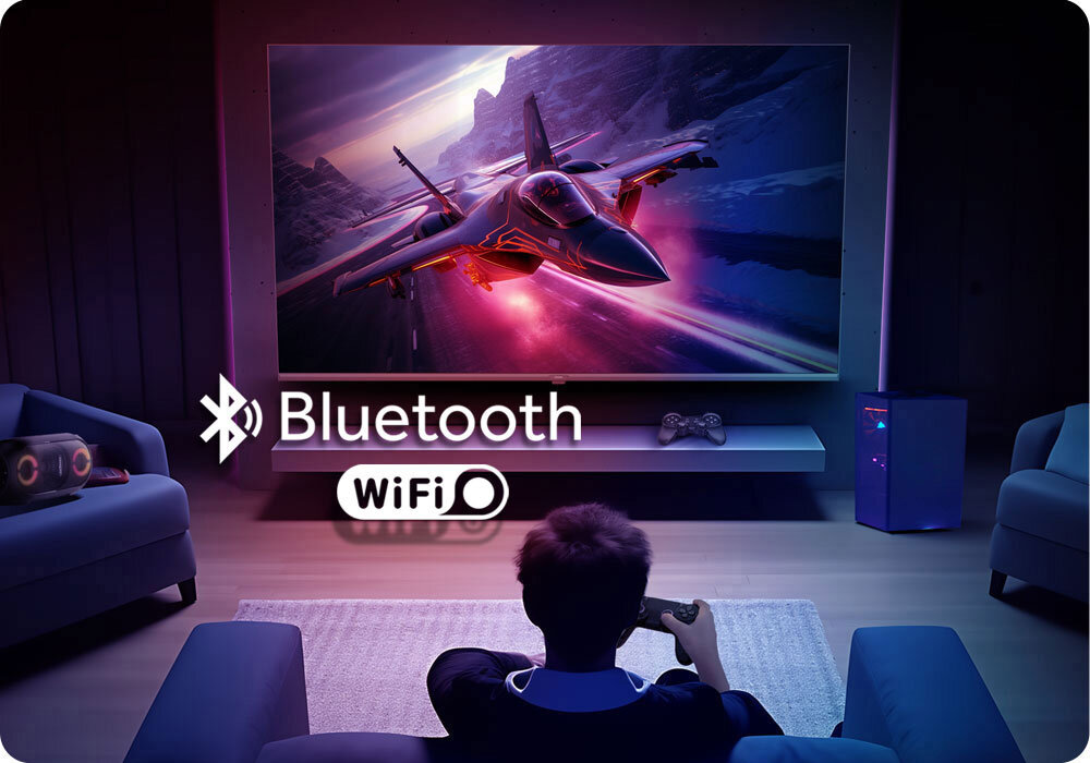 Telewizor HAIER H65S80FUX 65 QLED 4K 120Hz VRR Google TV HDMI 2.1 napis Bluetooth wifi osoba siedząca przed telewizorem