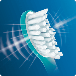 Obraz przedstawia główkę szczoteczki sonicznej z białymi włóknami na niebieskim tle. Wokół włókien widoczne są białe linie sugerujące ruch soniczny.