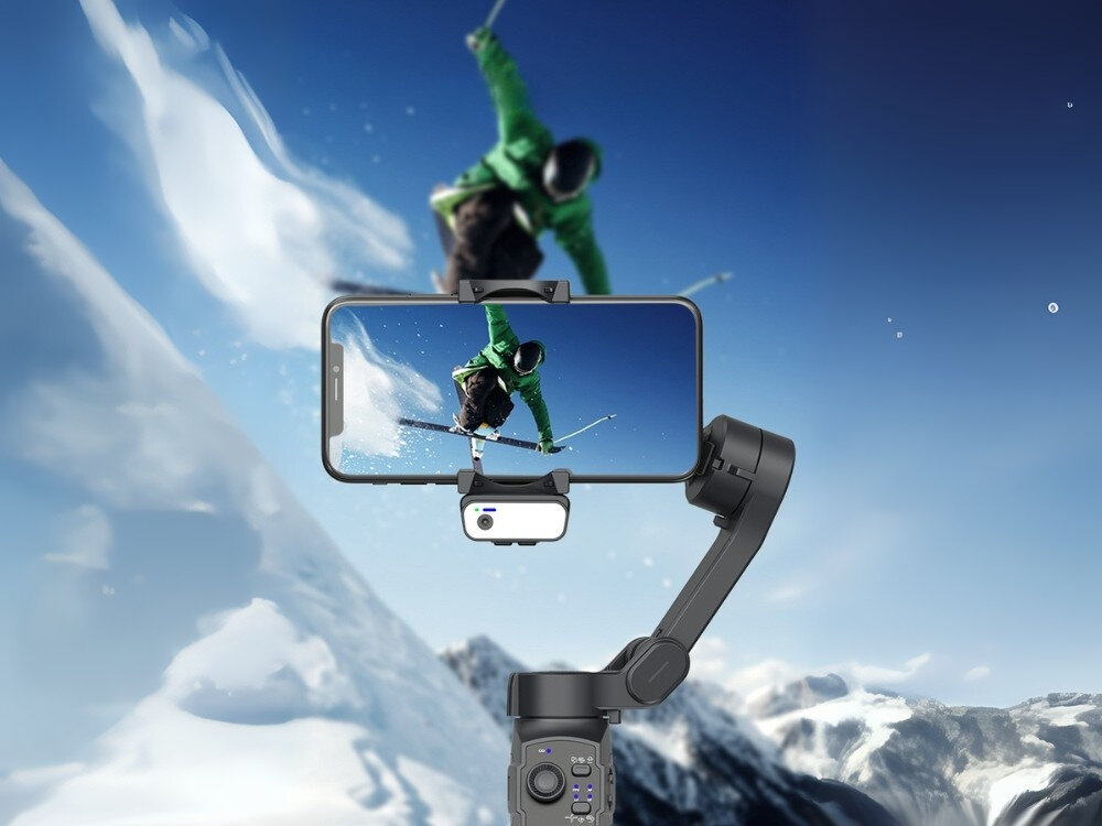 Gimbal MAJESTICLINE AJ Axis AI
stabilizator w dłoni z przymocowanym telefonem robiący zdjęcie trzyosiowa konstrukcja stabilizuje nagrania dynamiczne ujęcia filmowanie z ręki