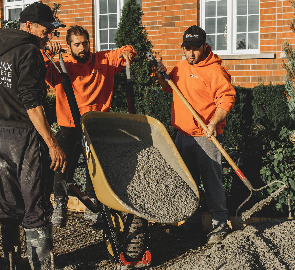 Taczka CAT J22-150, Solidność w trudnym terenie, Panowie wylewają beton z taczki