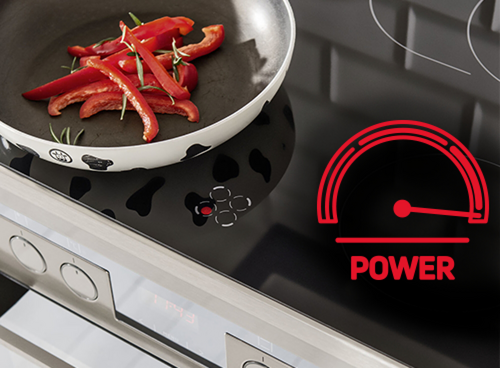 Płyta indukcyjna Amica z funkcją PowerBooster, patelnia z papryką i czerwony symbol mocy