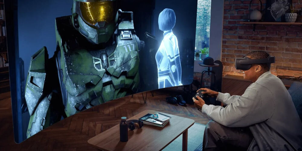 Gogle VR OCULUS Meta Quest 3S Xbox Edition 128GB Czarny prezentacja gogli podczas korzystania mężczyzna siedzący na kanapie w pokoju z ceglaną ścianą grający w grę wirtualny ekran przed nim stabilne i łatwe do dopasowania soczewki Fresnela ostry obraz system audio z dźwiękiem przestrzennym wbudowane czujniki śledzenie ruchu