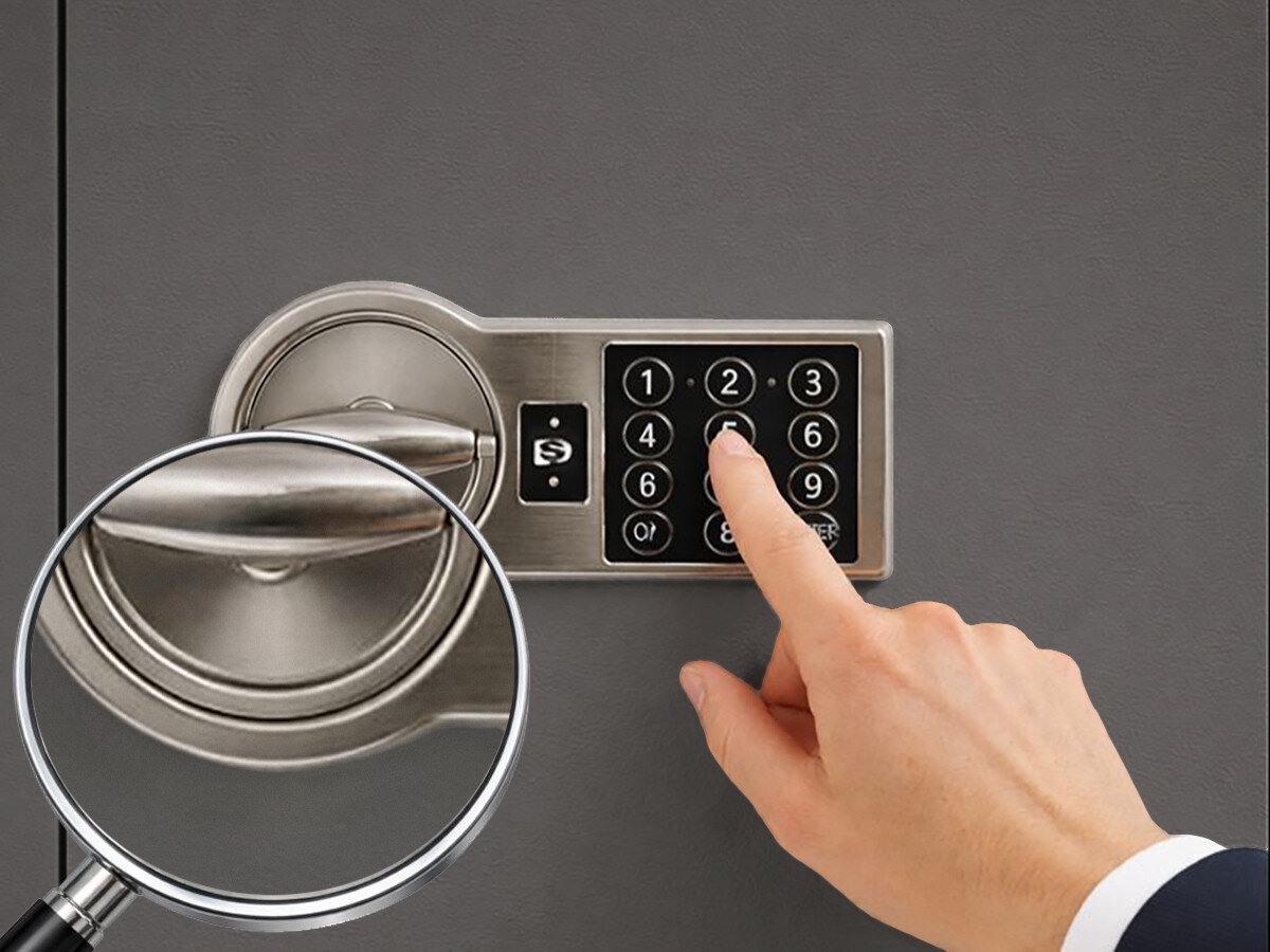 Sejf na broń VALBERG Arsenał 1253 EL Grafitowy, zamek, elektroniczny, kod, certyfikat, Palec wciska klawisze na elektronicznym panelu numerycznym zamka sejfowego, z powiększeniem na klawiaturę.