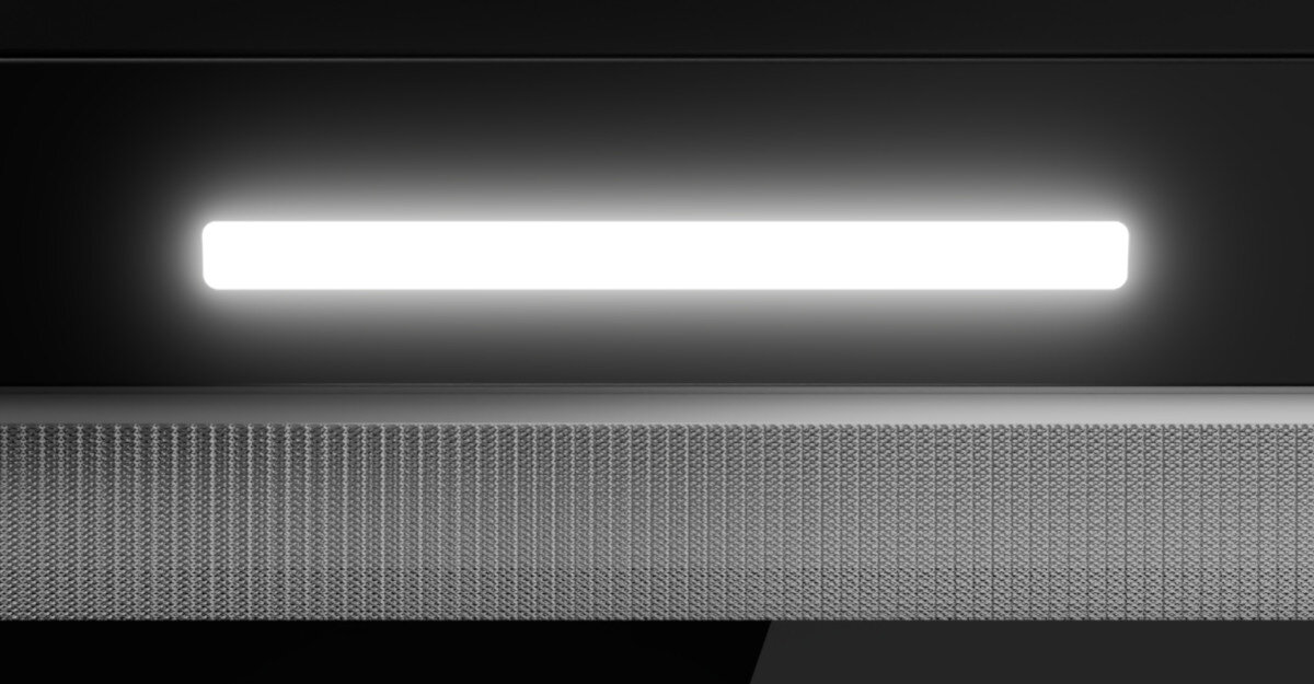 OKAP AKPO WK-9 CLARA CZARNY T500 Zdjęcie to zbliżenie na jasny pasek oświetlenia LED umieszczony w okapie, tuż nad metalową kratką filtra. Kontrast między gładką czernią a strukturą siatki podkreśla precyzyjne wykonanie urządzenia oświetlenie led energooszczędne światło gotowanie widoczność