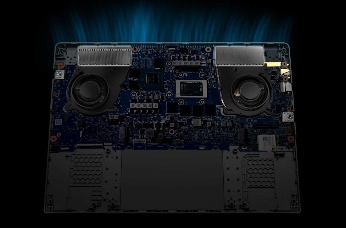 Wnętrze laptopa ASUS TUF Gaming z dwoma dużymi wentylatorami i zaawansowanym układem chłodzenia, widok na płytę główną i podzespoły, podświetlenie symbolizujące odprowadzanie ciepła. -  chłodzenie, Wentylatory Arc Flow 2. generacji 