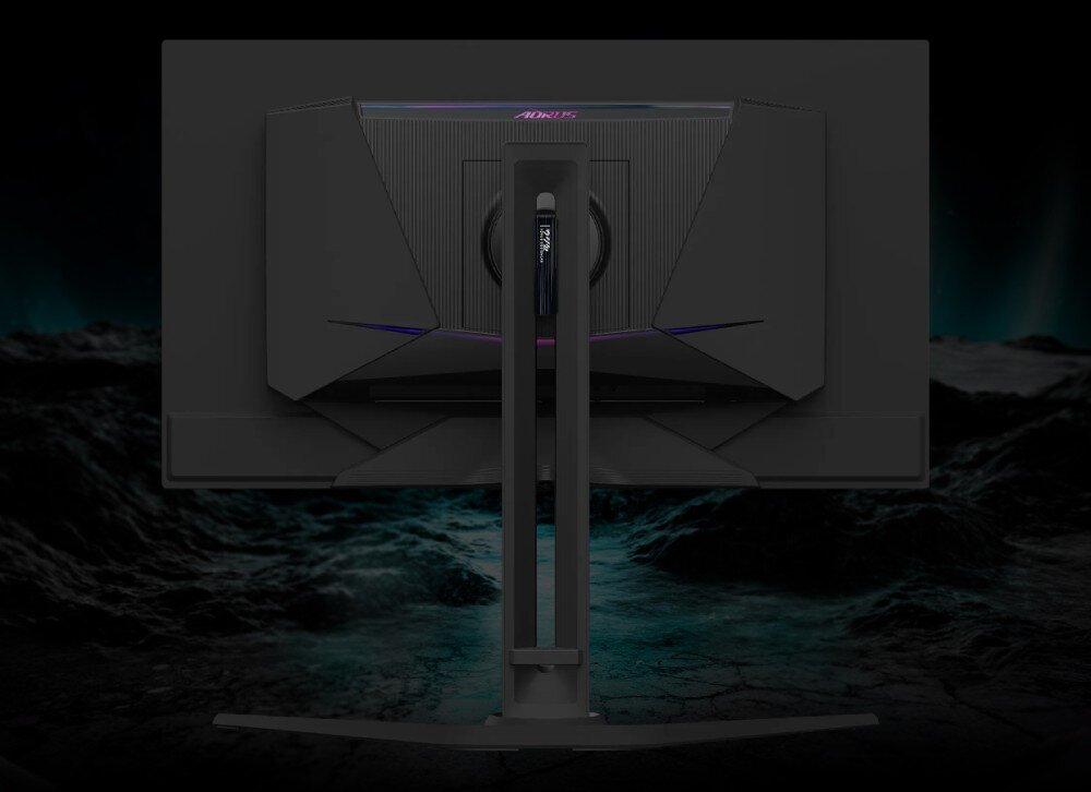 Monitor GIGABYTE Aorus FO27Q5P Tył monitora komputerowego zamontowanego na stojaku na ciemnym tle imitującym kamienne podłoże