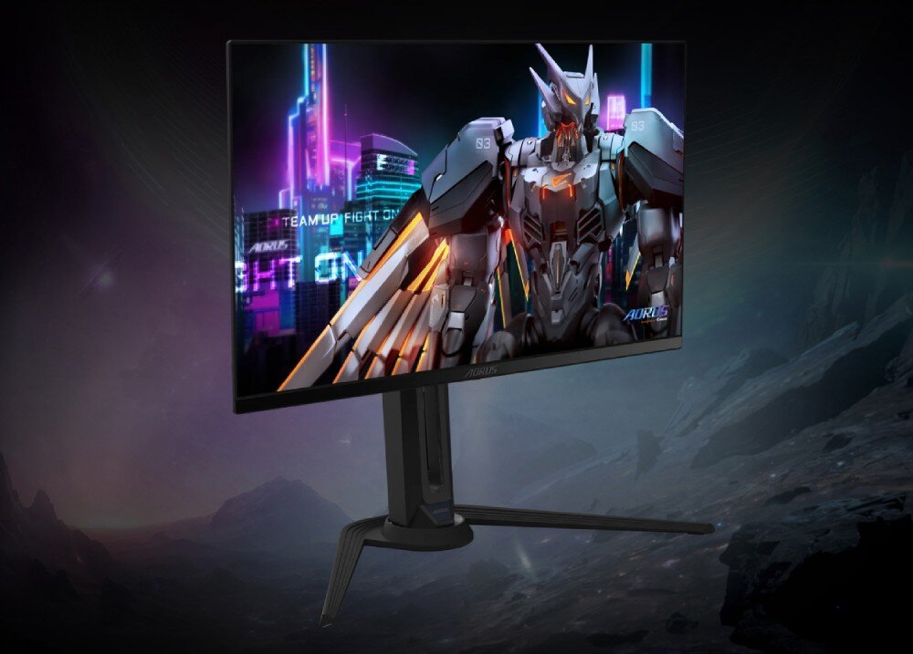 Monitor GIGABYTE Aorus FO27Q5P Monitor komputerowy na szerokiej podstawie ustawiony pod kątem, na ekranie wyświetla się postać robota w futurystycznym mieście