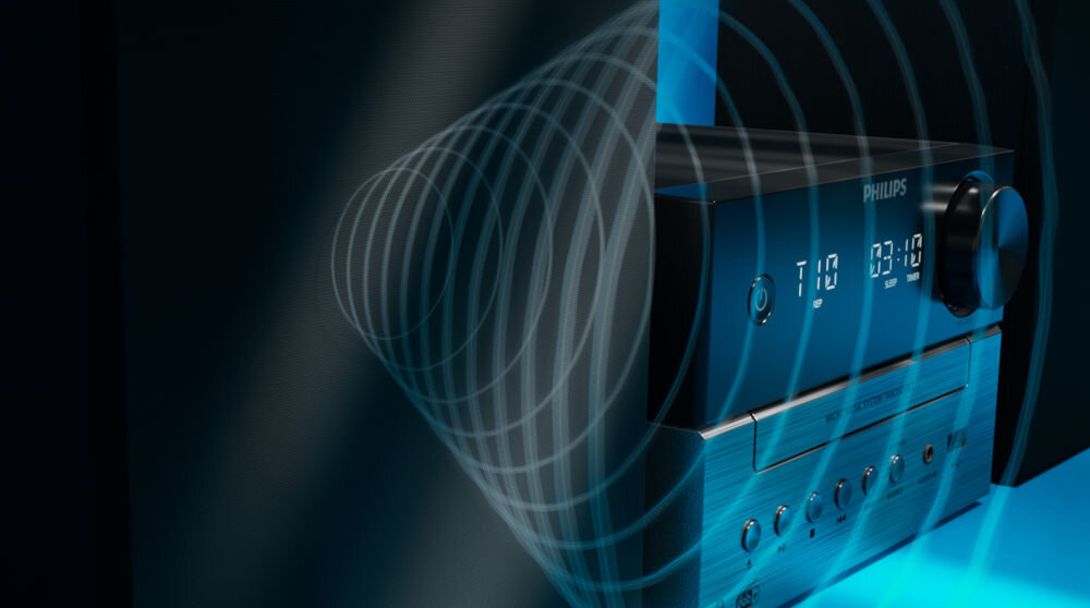Czarna wieża audio z wyświetlaczem pokazującym godzinę 03:10 i logo PHILIPS. Obok urządzenia widoczne są fale dźwiękowe, a na panelu znajdują się przyciski i pokrętło.