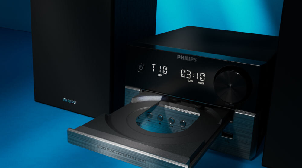 Czarna wieża audio z otwartą szufladą na płyty CD, wyświetlaczem pokazującym \'T10\' i \'03:10\', oraz logo \'PHILIPS\'.