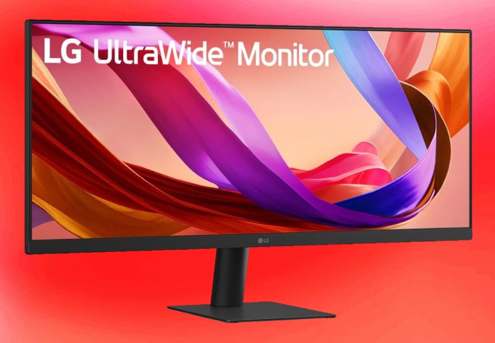 Monitor LG UltraWide 29U511A-B Monitor na tle czerwonego gradientu z kolorową grafiką w postaci falistych wstęg na ekranie oraz widoczną czarną podstawą