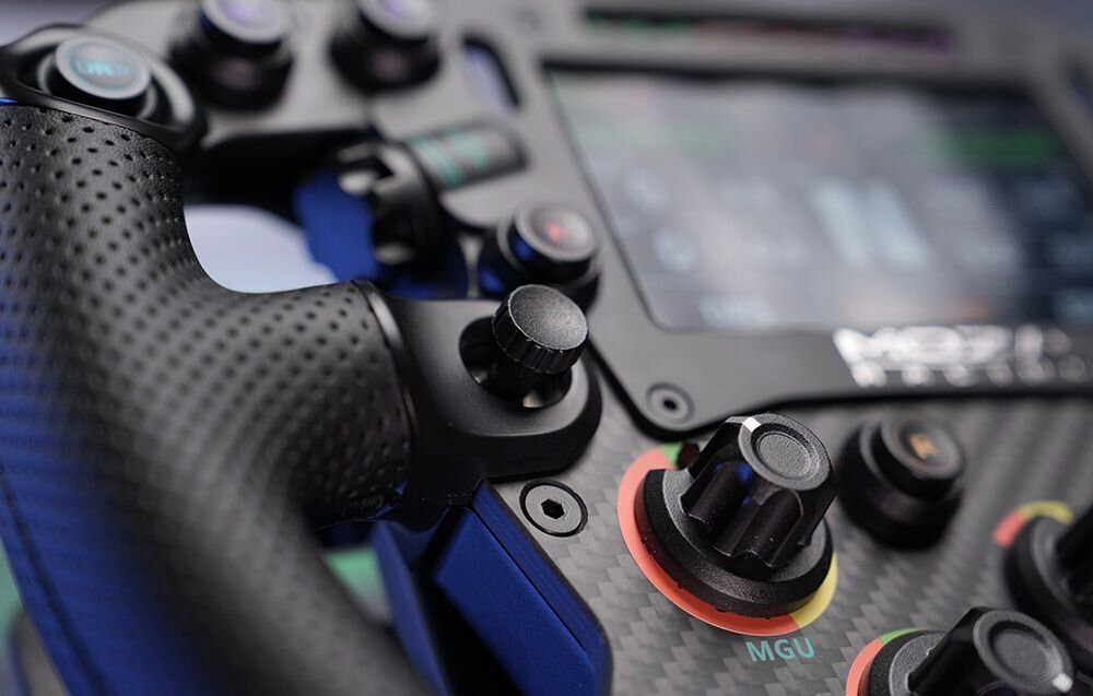 Kierownica MOZA Racing FSR V2 RS068 PC Widok z bliska na kierownicę gamingową Moza Racing z przyciskami i pokrętłami 10 podświetlanych przycisków 5 enkoderów 2 pokrętła 2 przełączniki 7-kierunkowe dostosowuj bez odrywania dłoni