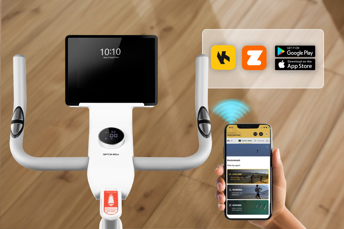 Rower elektromagnetyczny SPOKEY Zen, Bluetooth, technologia, interaktywność, postęp, Rower Spokey z Bluetooth, appkami Zwift i tabletem pokazującym czas 10:10.