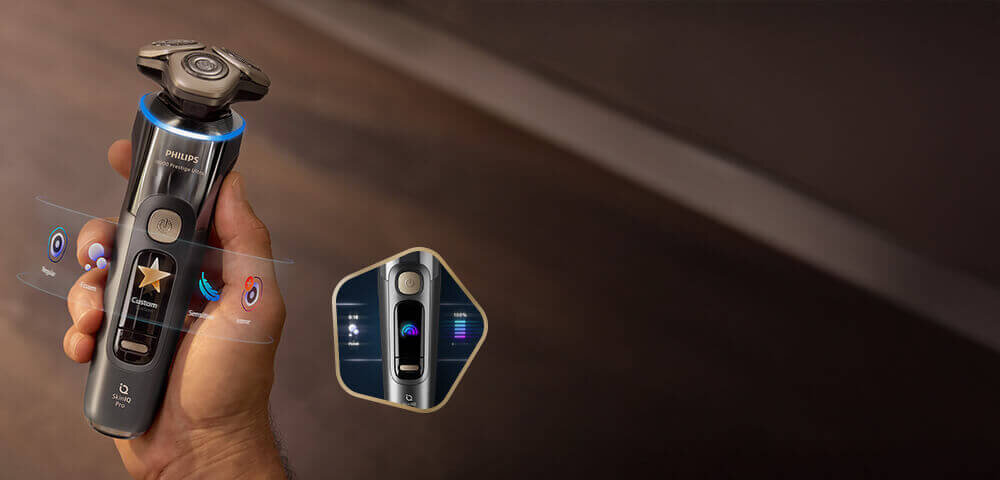 Głowice golarki z niebieskimi świetlnymi pięciokątami i strzałkami skierowanymi do wewnątrz. Obok małe zdjęcie golarki z głowicami przy twarzy i zielonym ringiem.