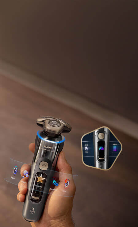 Głowice golarki z niebieskimi świetlnymi pięciokątami i strzałkami skierowanymi do wewnątrz. Obok małe zdjęcie golarki z głowicami przy twarzy i zielonym ringiem.