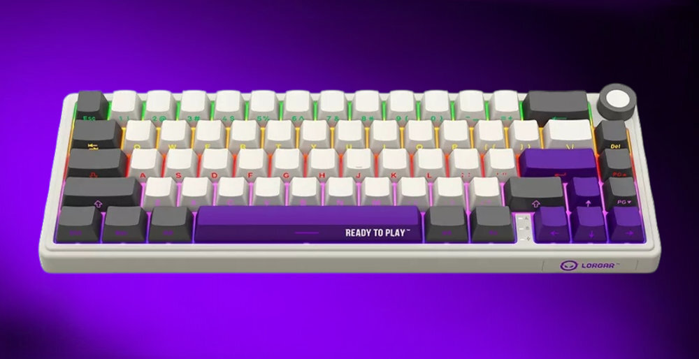 Klawiatura mechaniczna z beżowymi i fioletowymi klawiszami, na jednym z klawiszy widoczny napis \'READY TO PLAY\'. W prawym dolnym rogu znajduje się logo \'LORGAR\'.
