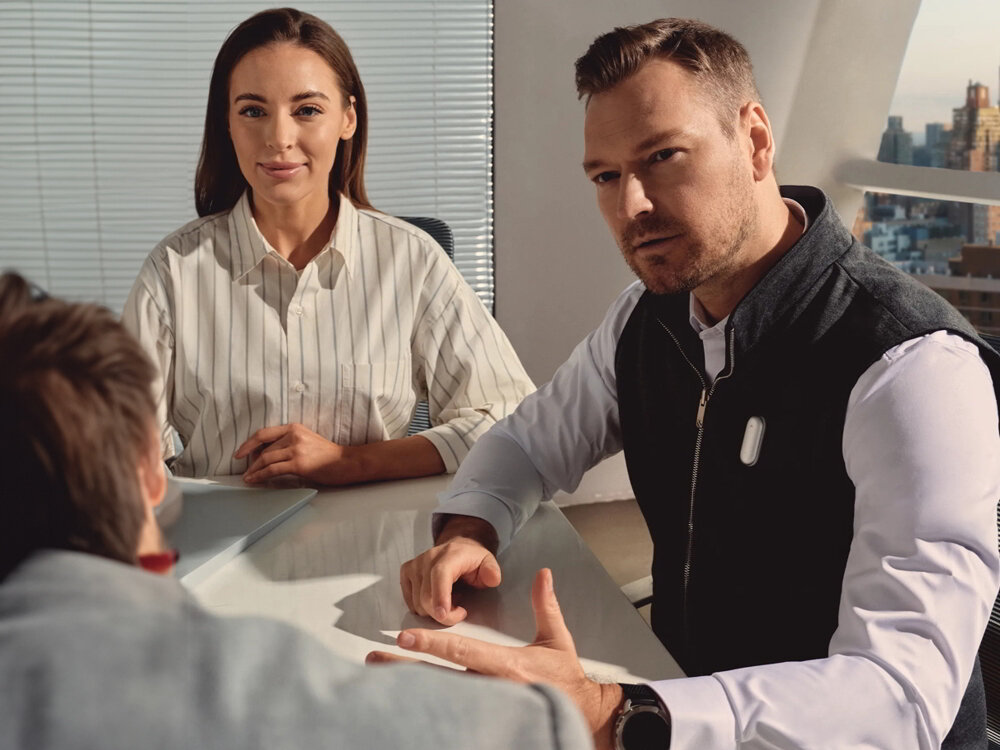 Dyktafon AI PLAUD NotePin notatki transkrypcje ChatGPT Gemini Pro Claude Sonnet, osoby uczestniczące w spotkaniu biznesowym, osoba z przypiętym dyktafonem